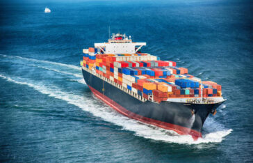 A large cargo container ship out to sea.